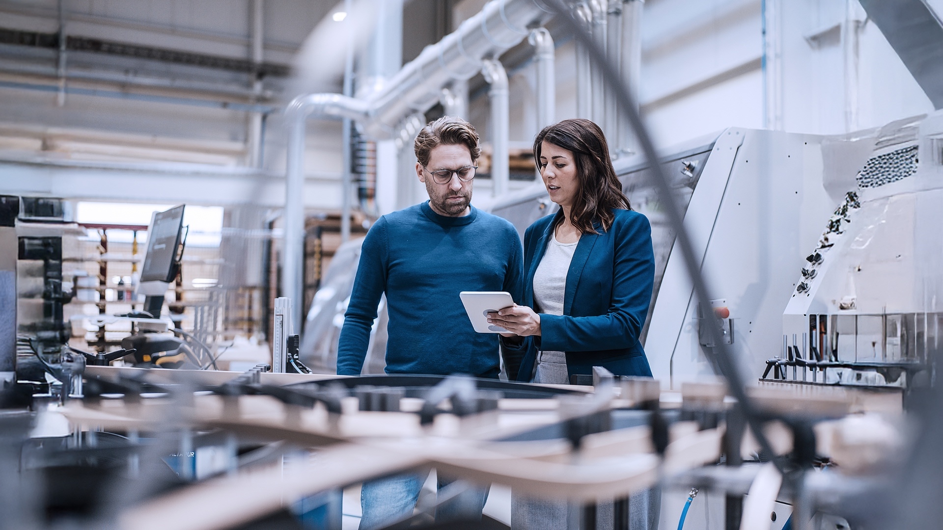 Zwei Fachkräfte betrachten Tablet, steht für Entscheidungsfindung 