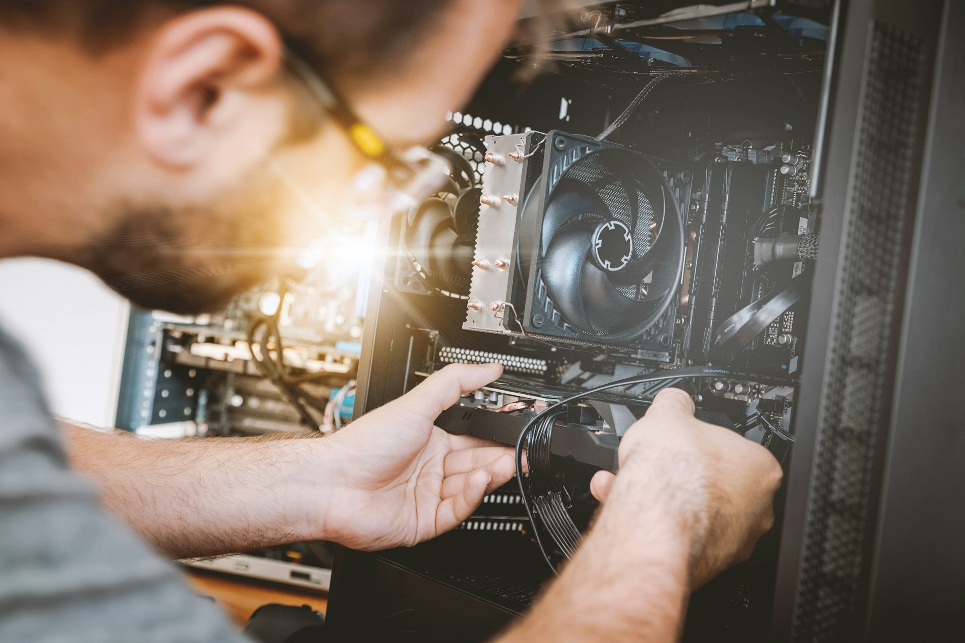 A man processes an electronic product on a computer.